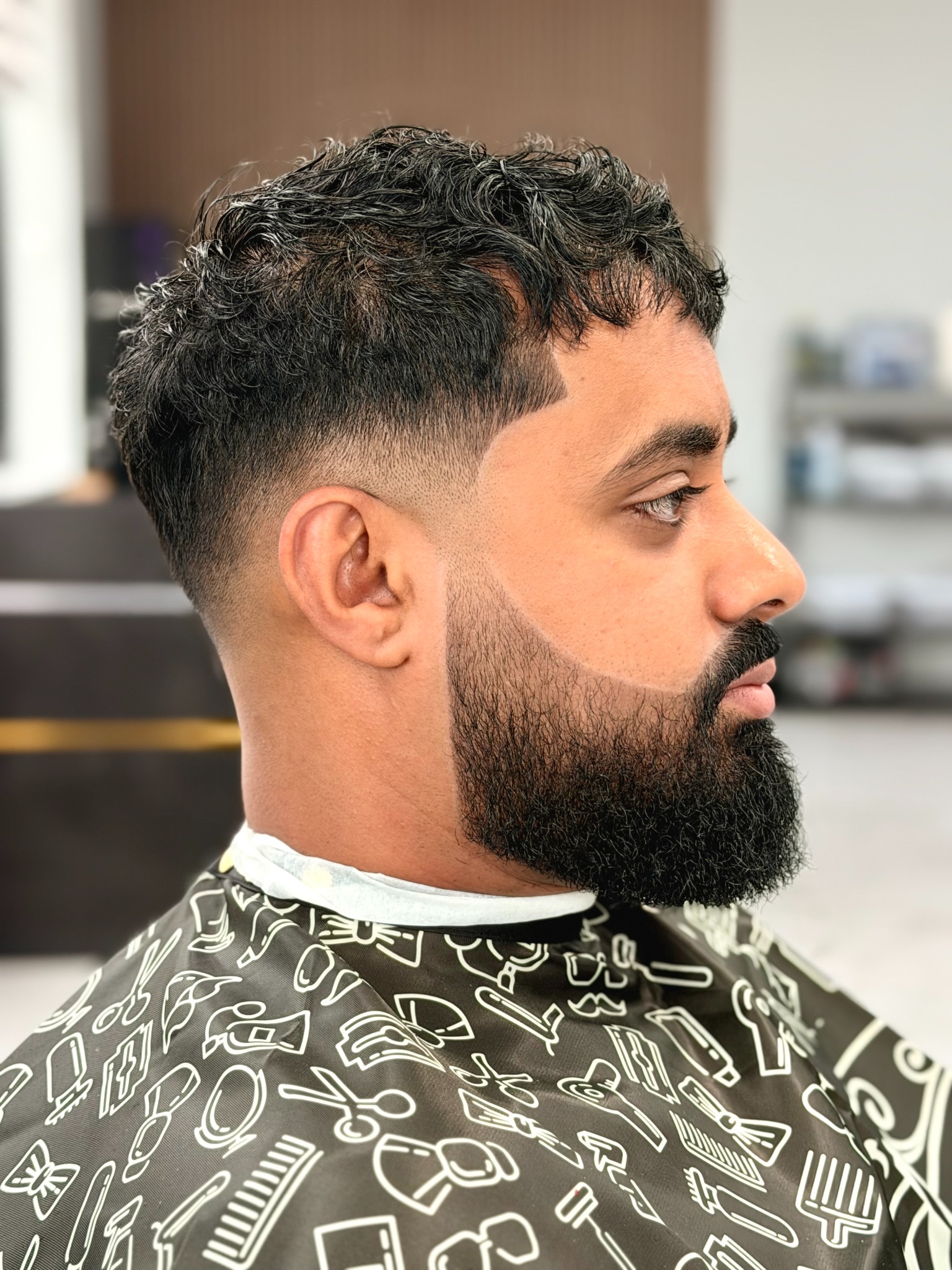 Haircut with fade, shaped beard and clean lineup