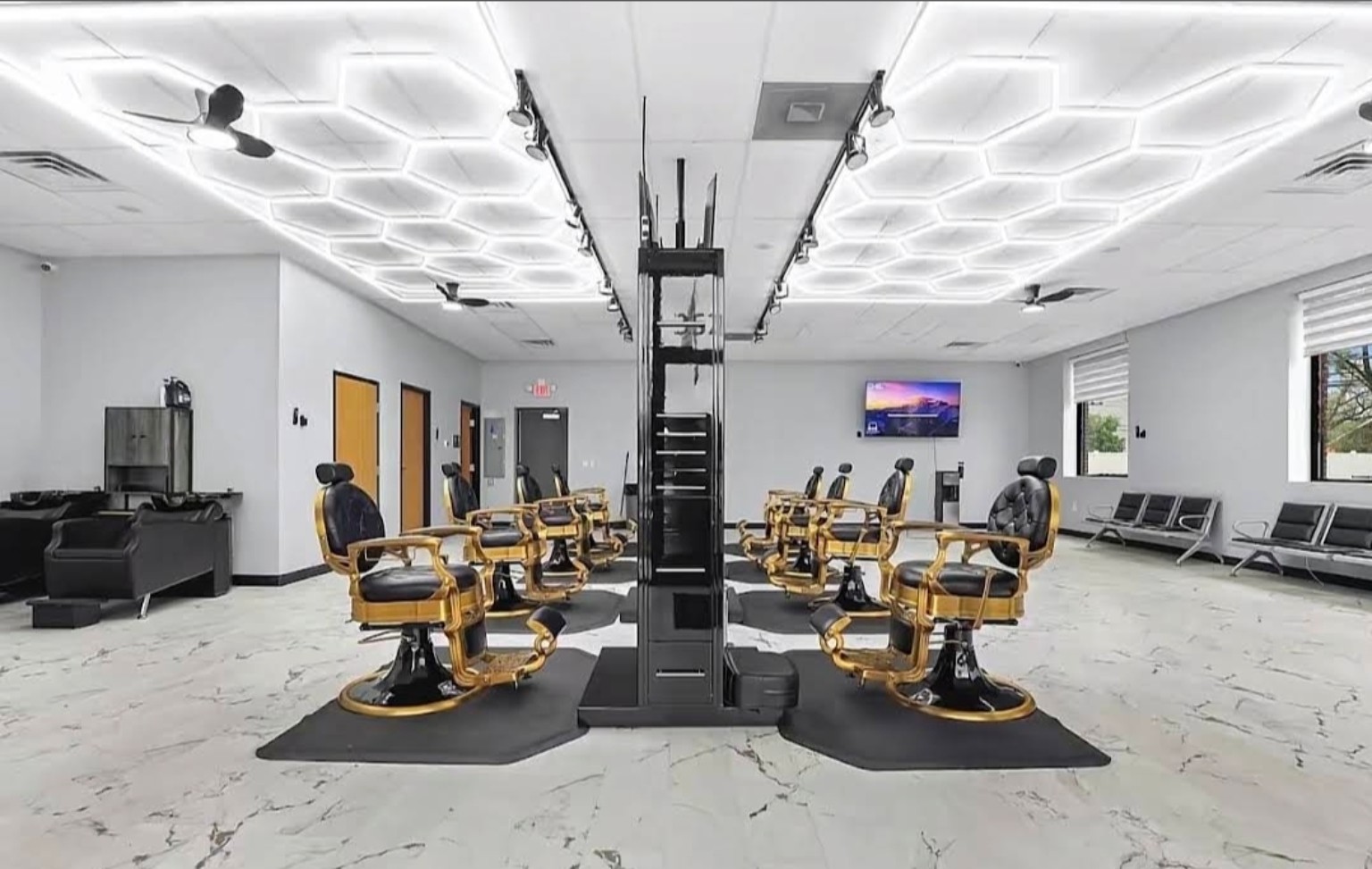 Gold barber chairs and bright modern interior at Motor City Clippers